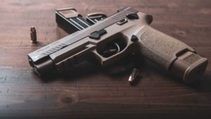Sig M17 on dark wooden table